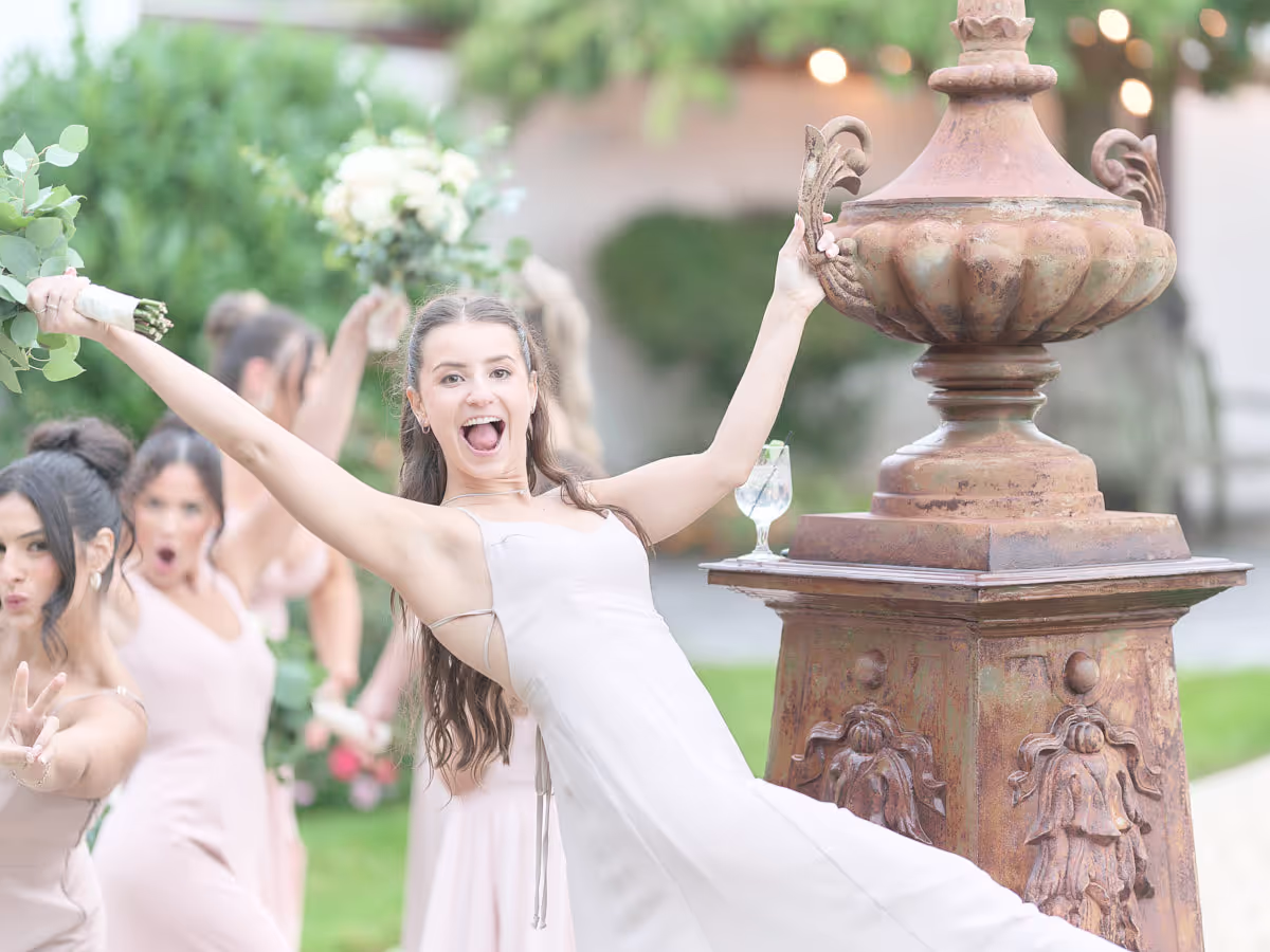 Candid celebration with the wedding party, bouquets in the air