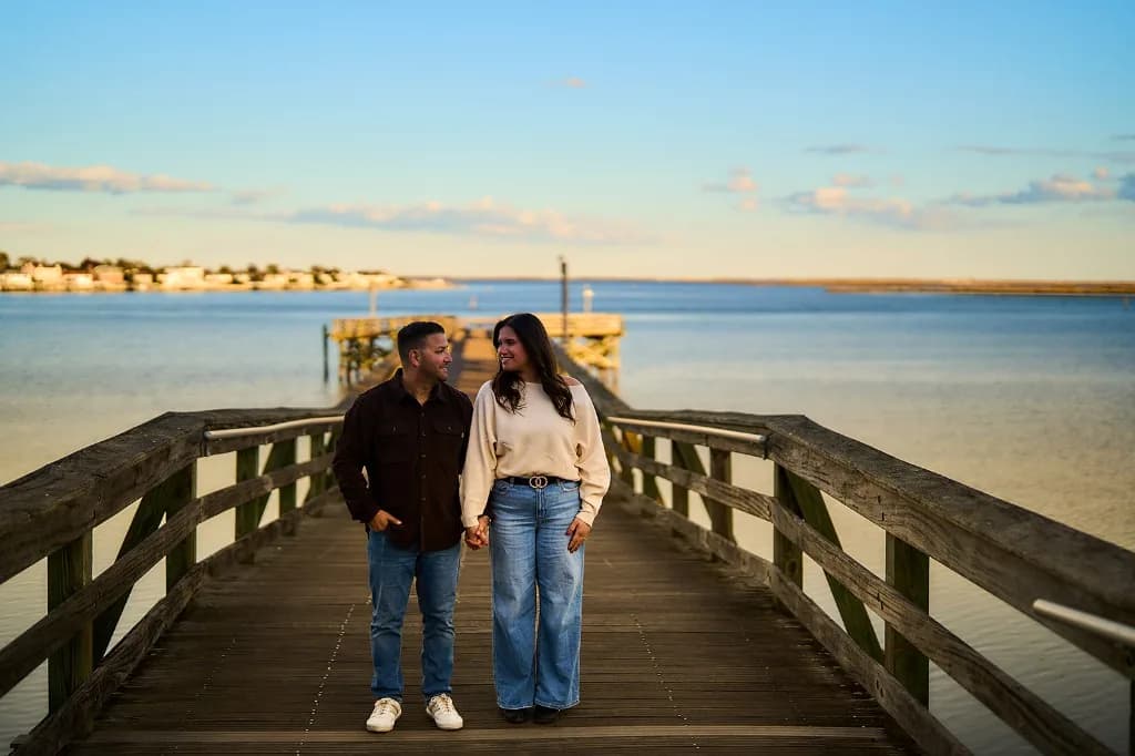 Engaged couple on a dock over a calm Long Island bay