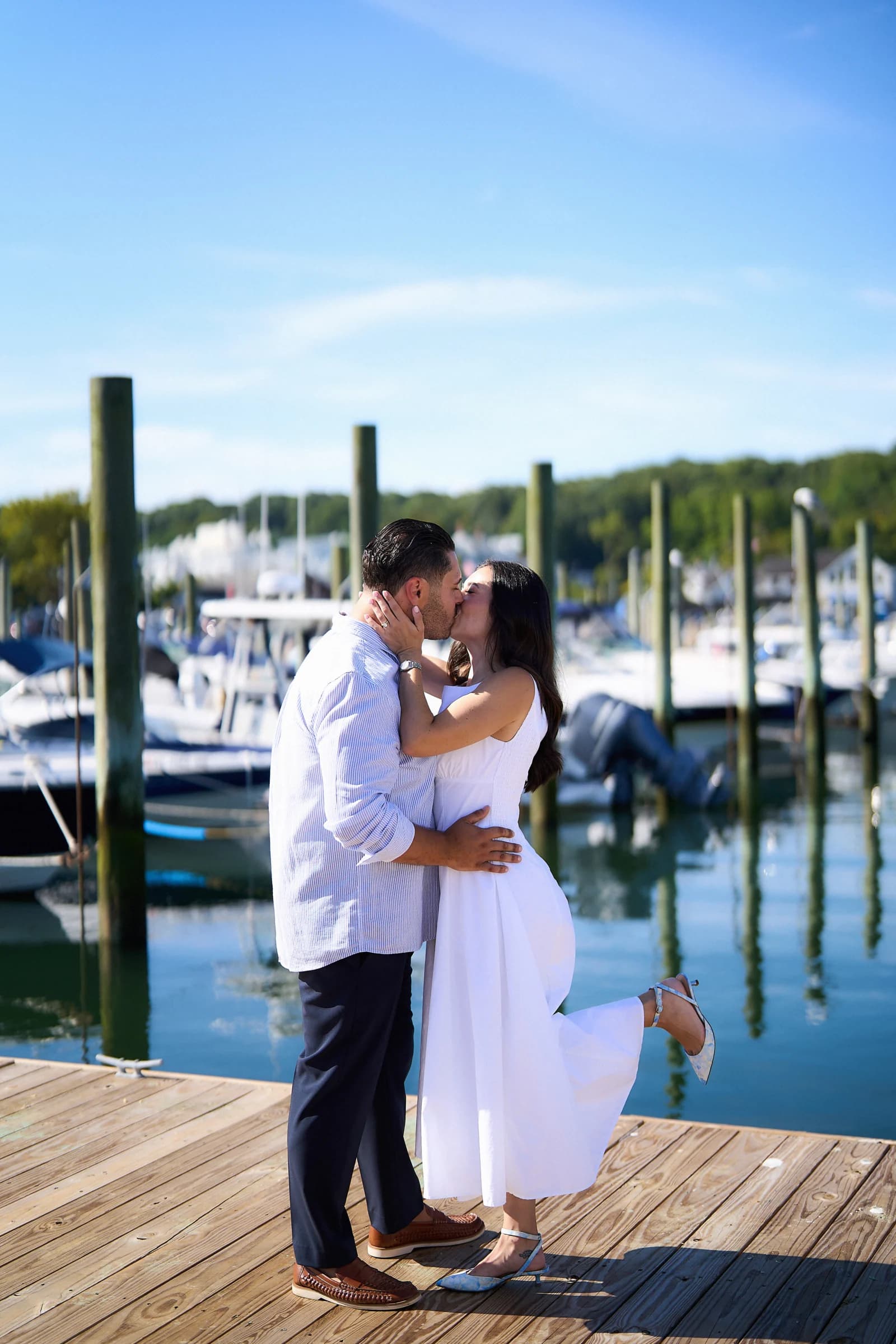 Elizabeth and Rocco kiss on the dock at Port Jefferson Harbor