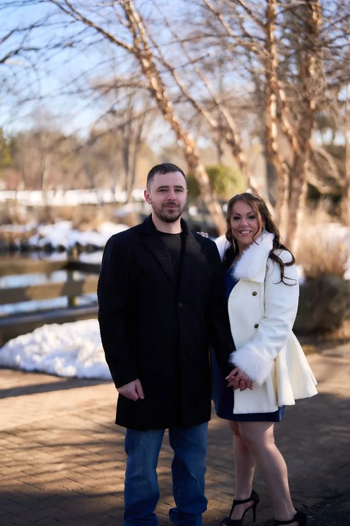 Engaged couple walking a quiet winter path together