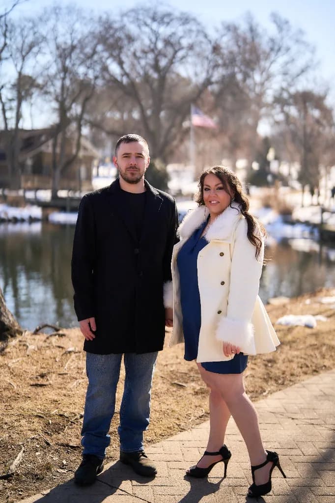 Couple among bare winter trees in soft light