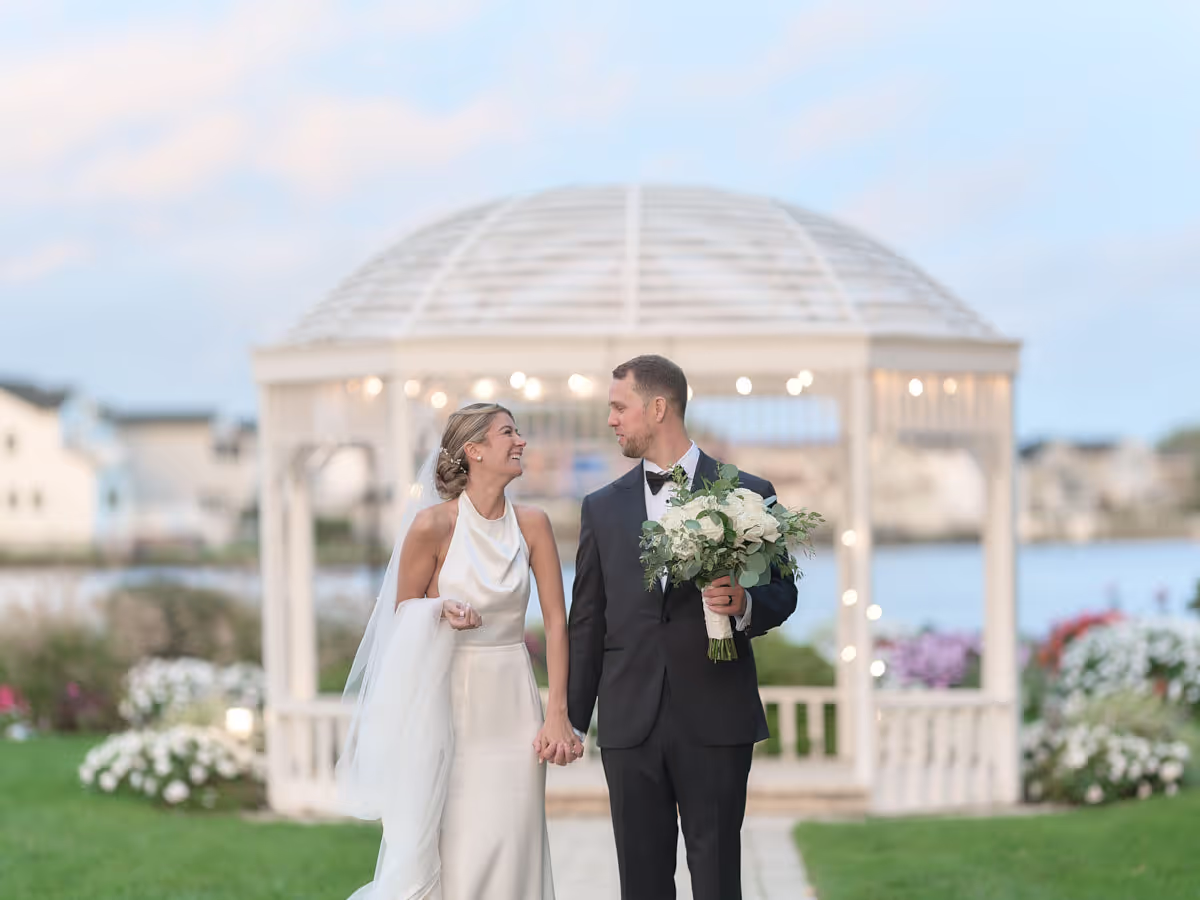 Crescent Beach Club, Bayville, Couple in front of a lit waterfront gazebo at dusk