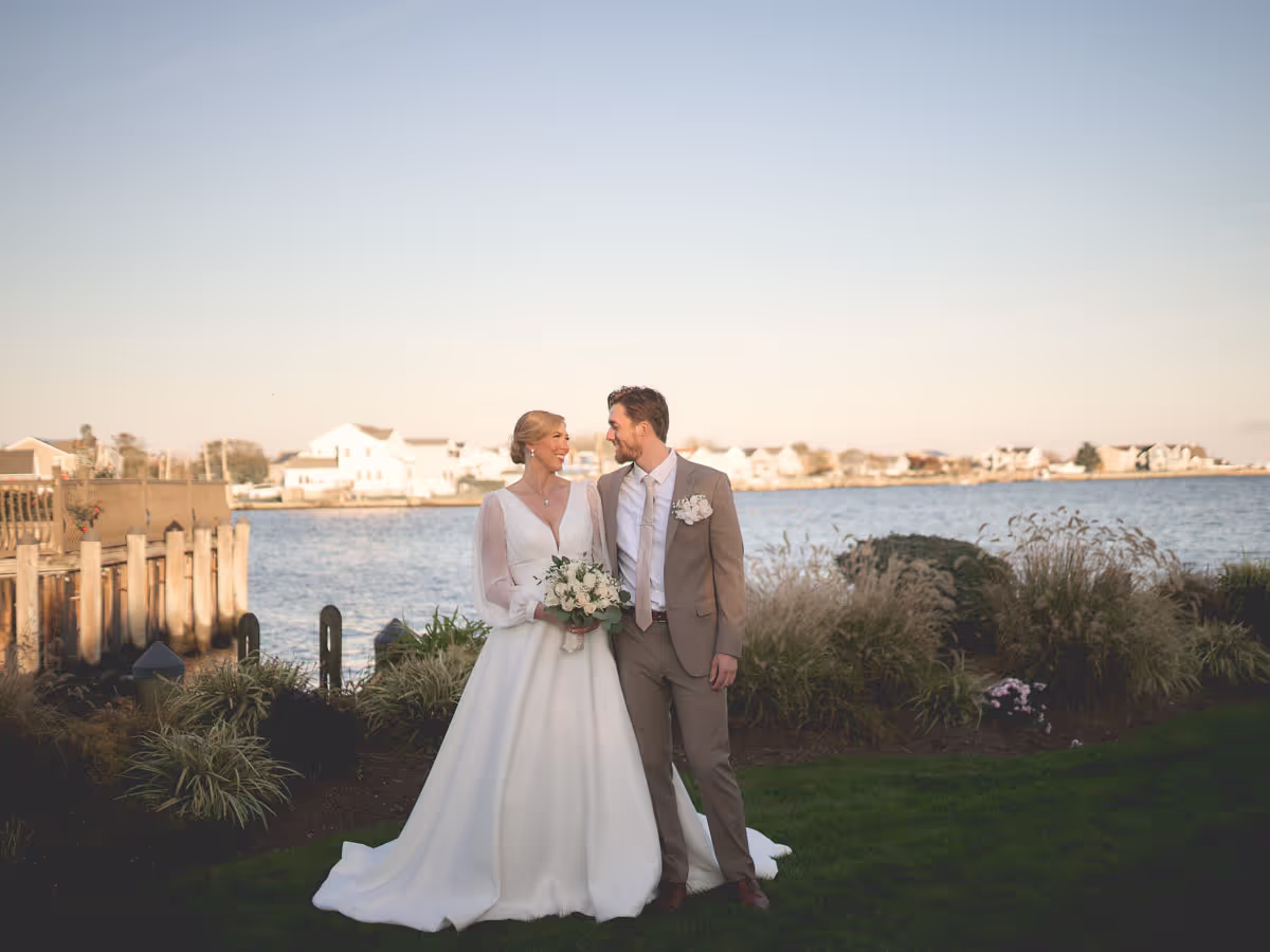 Grand staircase against a hotel ballroom, Bride and groom on a harborfront lawn at sunset