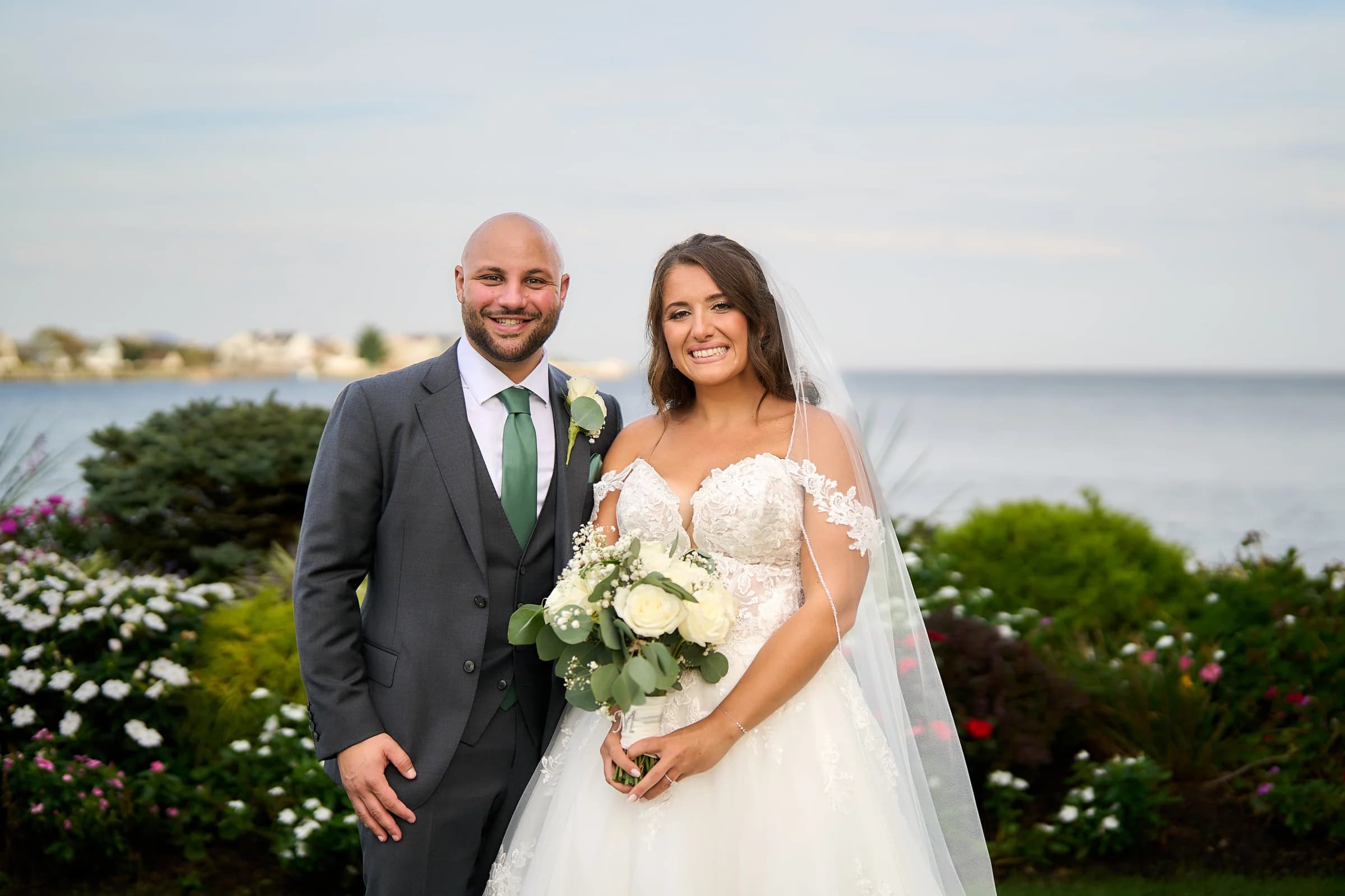 Cherry Valley Club, Garden City, Amanda and Gabriele smiling beside the bay at the Riviera Waterfront Mansion