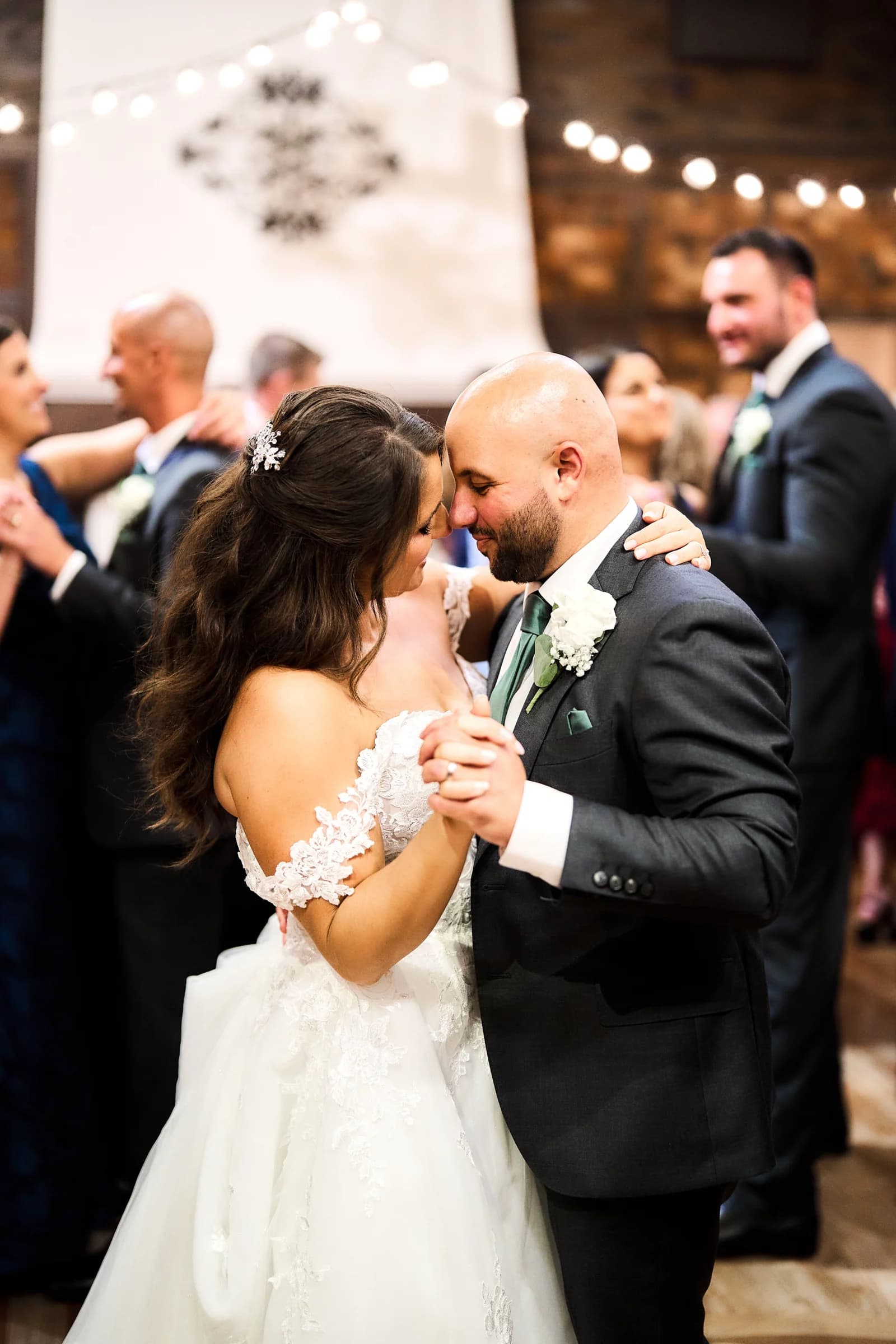 Amanda and Gabriele during their first dance, foreheads together