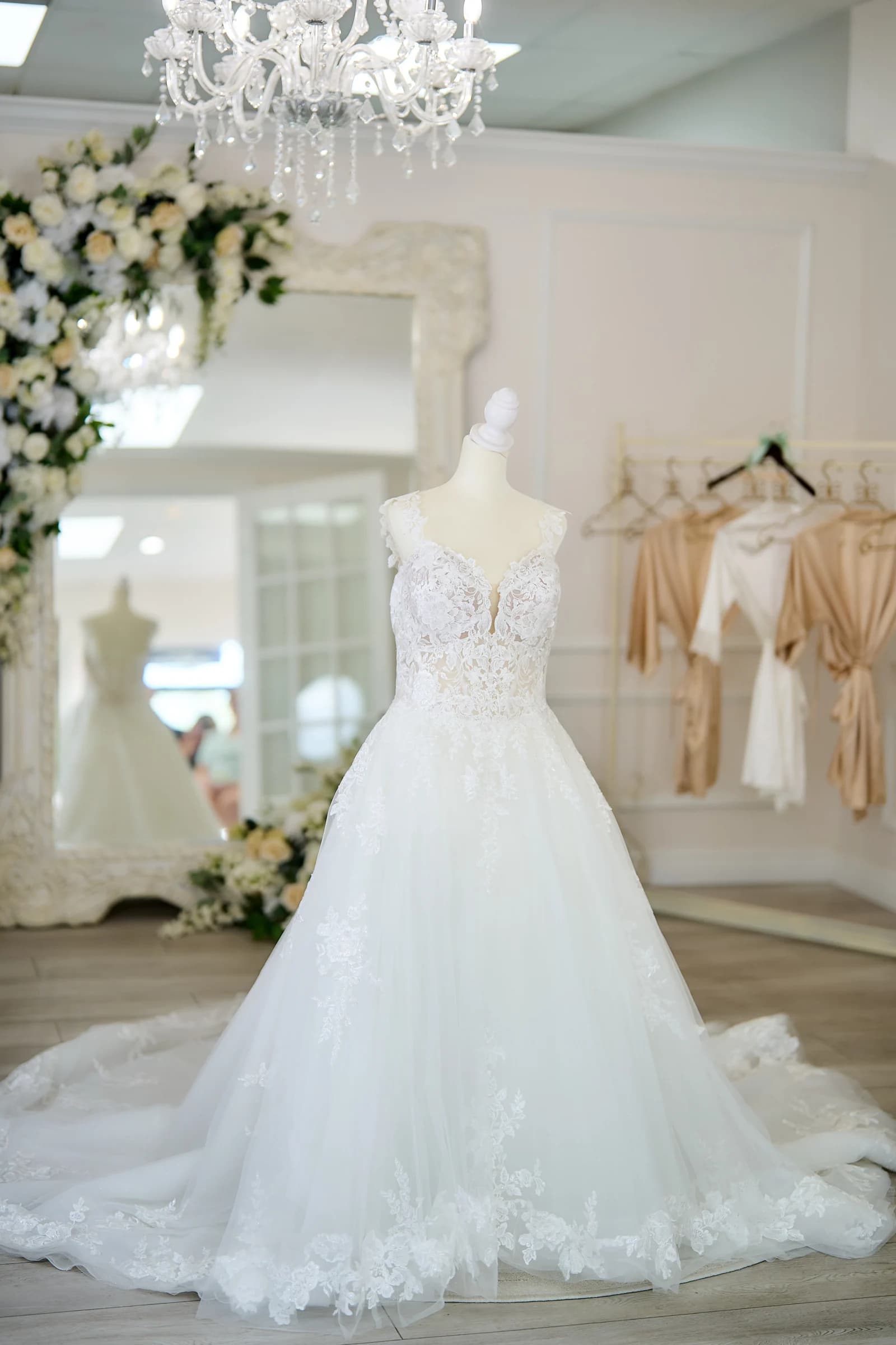 Amanda's full lace wedding gown and train on a mannequin in the bridal suite