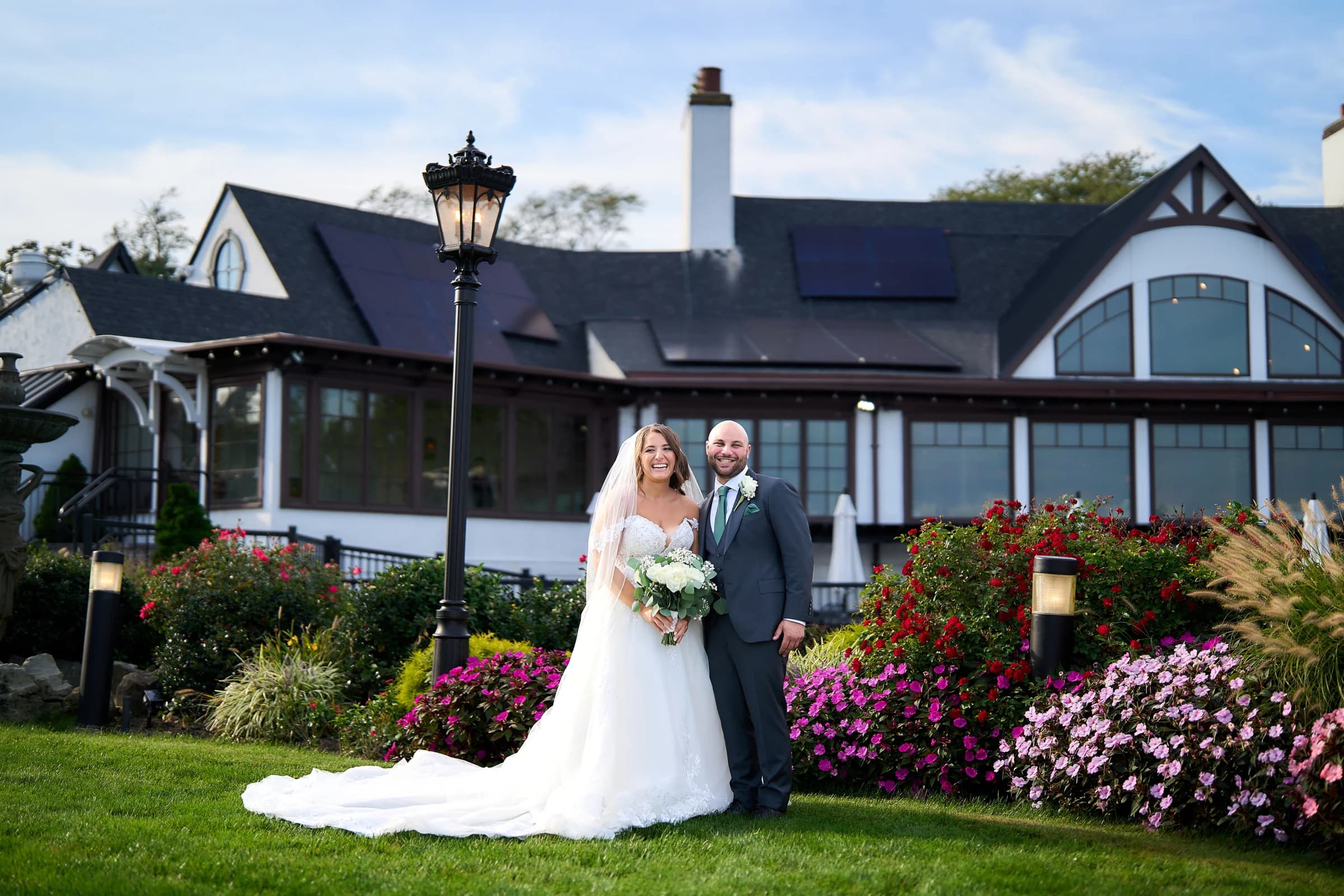 Amanda and Gabriele on the lawn in front of the Riviera Waterfront Mansion