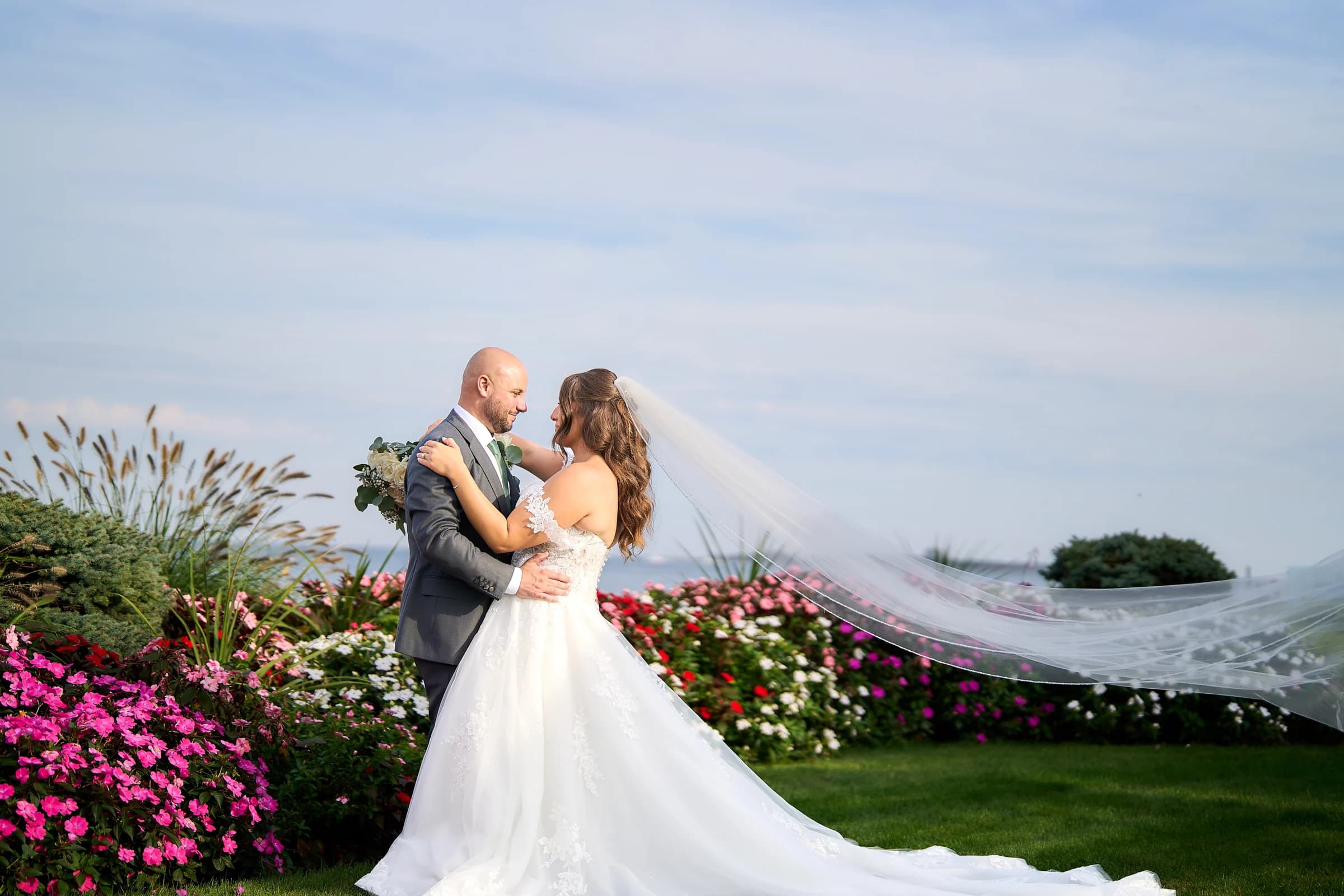 Amanda's veil blowing across the lawn as she and Gabriele embrace beside the bay