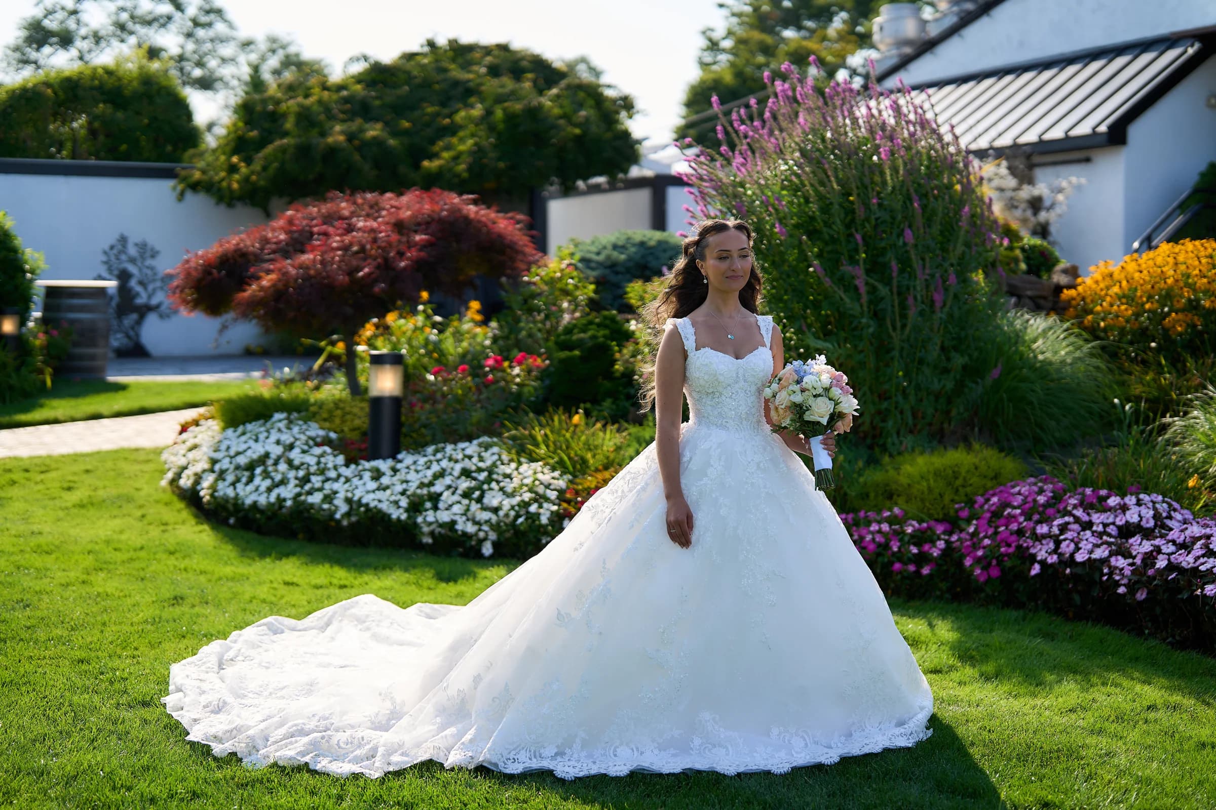 The Larkfield, East Northport, Gabriela in her lace gown with the train spread across the lawn at the Riviera