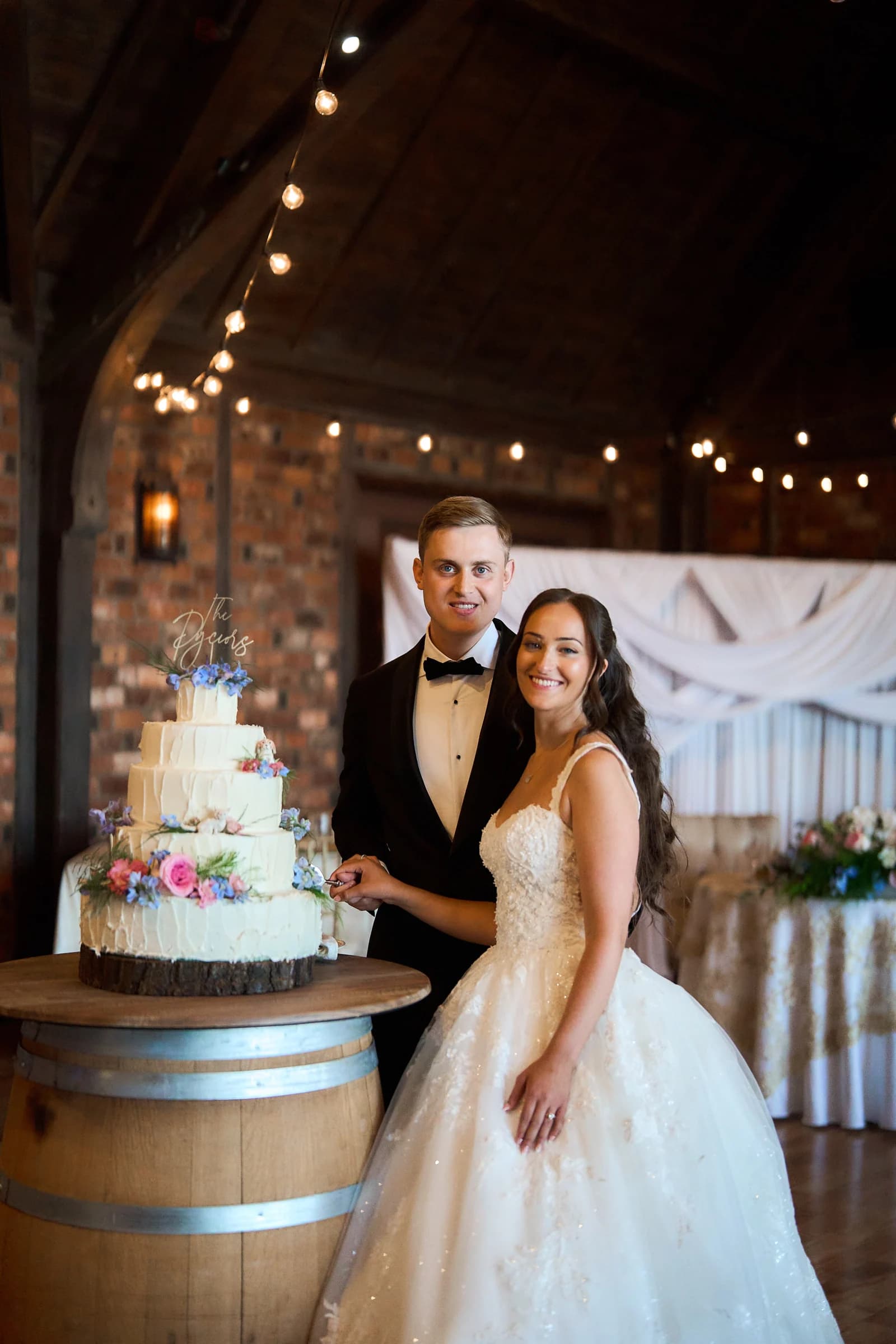 Grand staircase against a hotel ballroom, Gabriela and Jakub cutting their wedding cake at the Riviera Waterfront Mansion