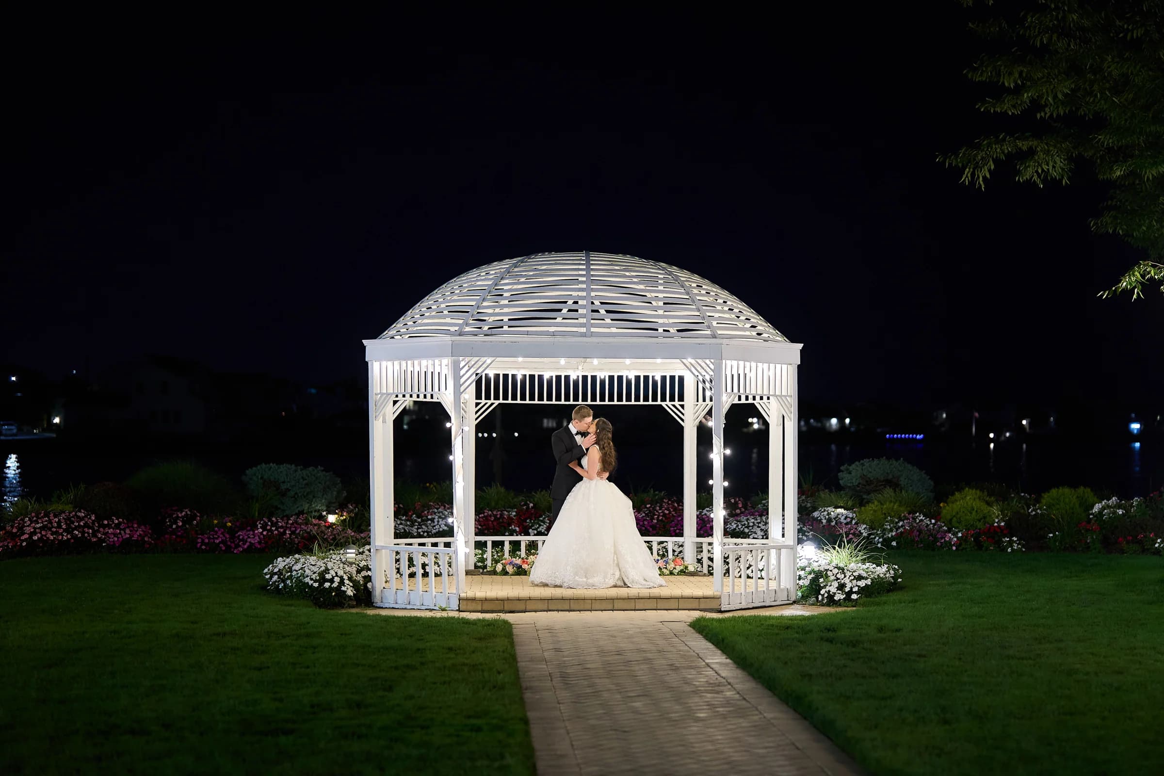 Glen Head Country Club, Glen Head, Gabriela and Jakub kiss under the lit gazebo at the Riviera Waterfront Mansion at night
