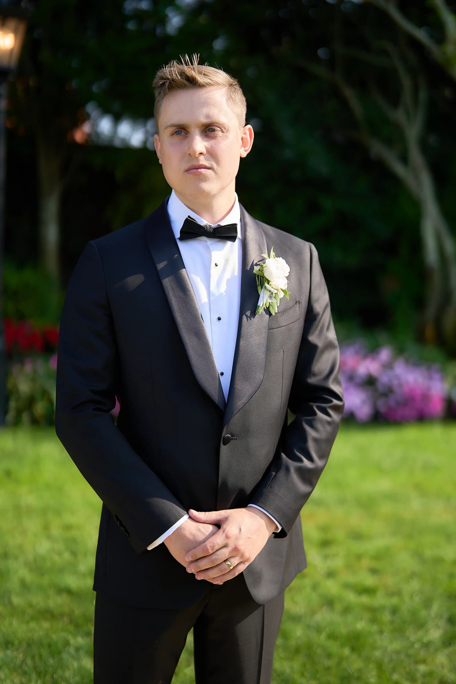 Jakub Pycior in a black tuxedo with a white rose boutonniere