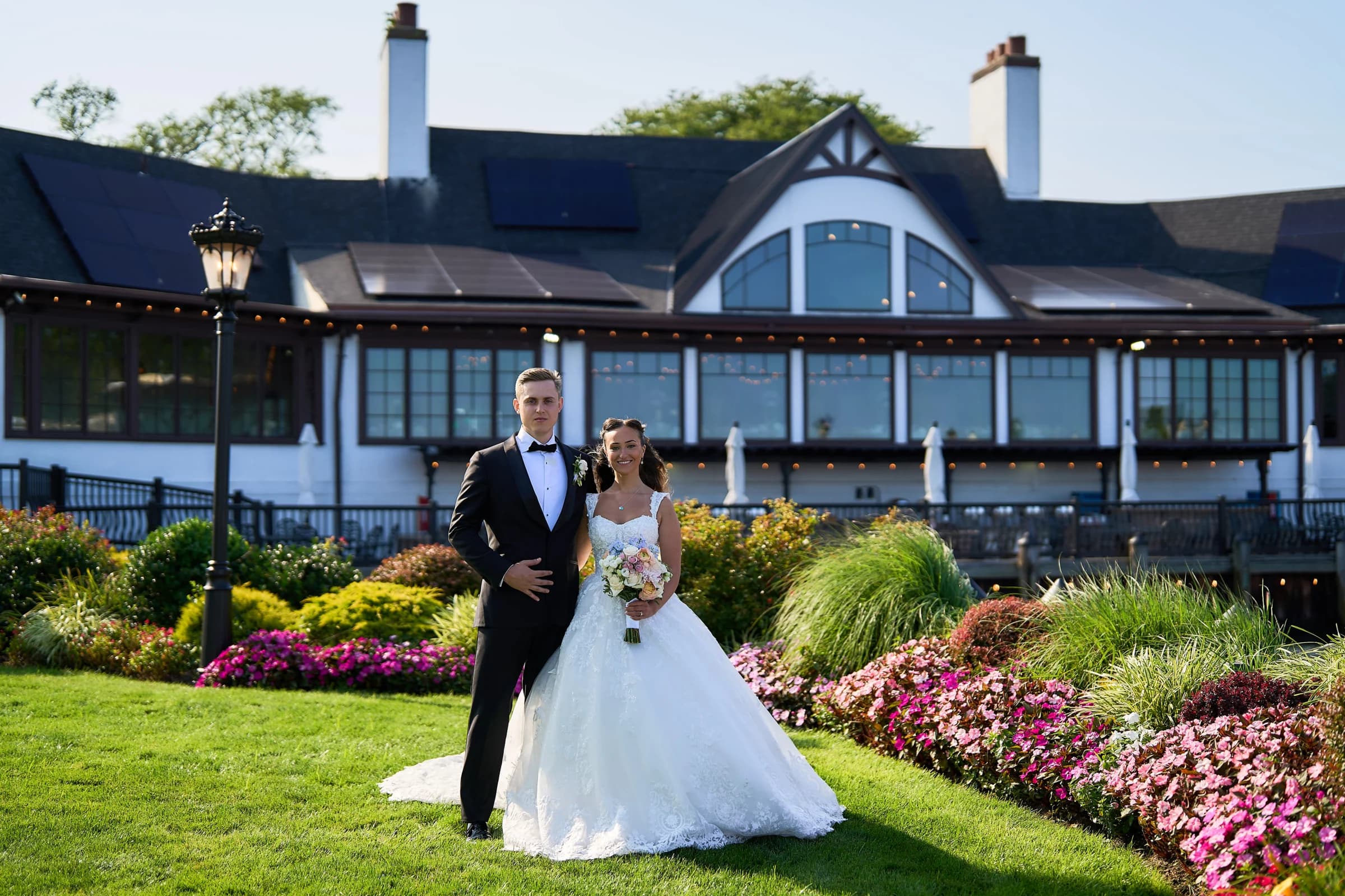 Gabriela and Jakub on the lawn in front of the Riviera Waterfront Mansion