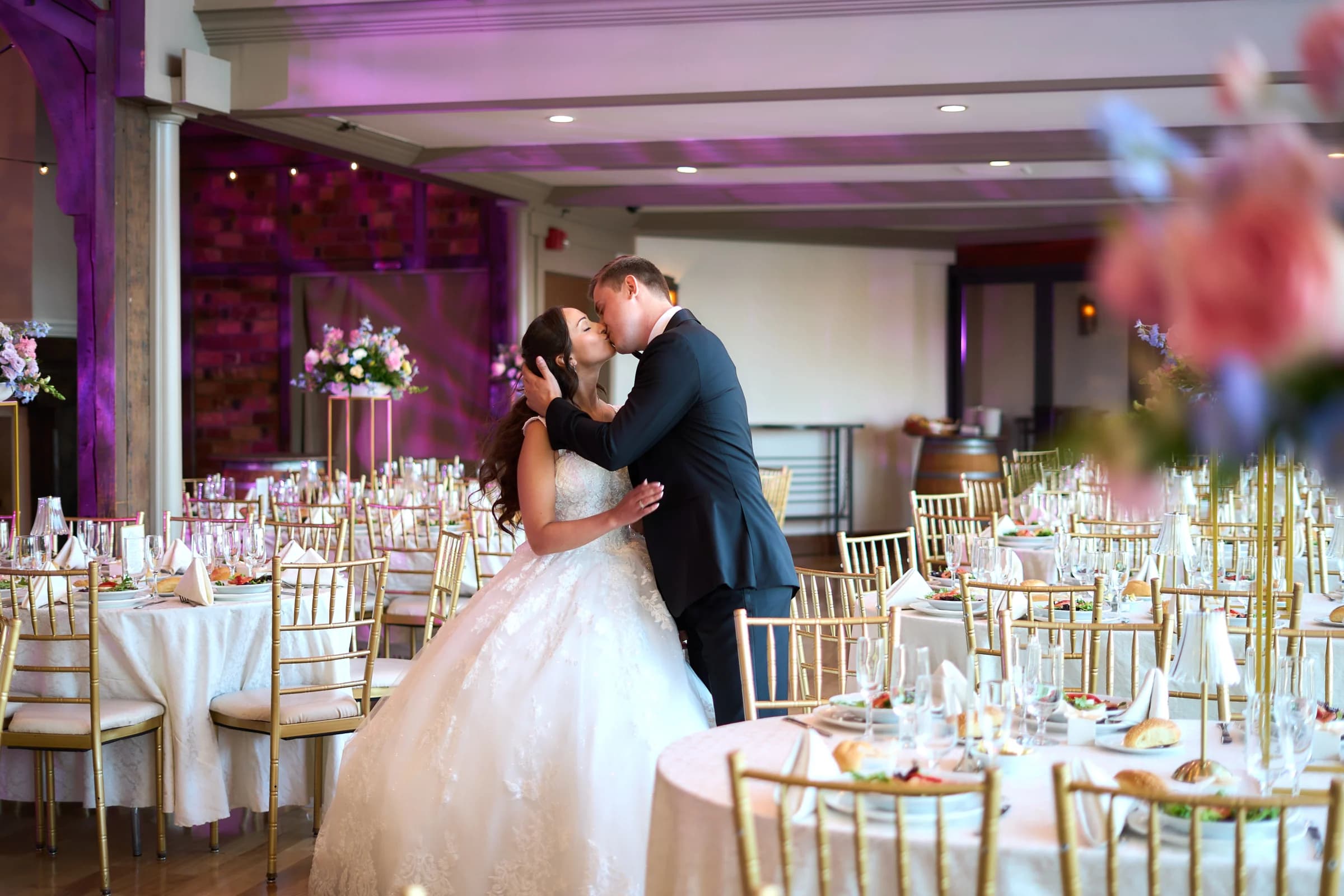 The Piermont, Babylon, Gabriela and Jakub kiss among the reception tables at the Riviera Waterfront Mansion