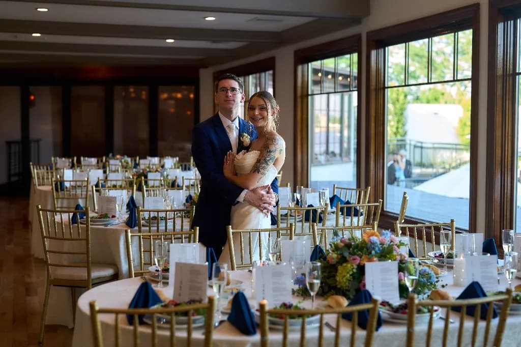 Hotel staircase against estate grounds, Bride and groom portrait in the ballroom with string lights at the Riviera Waterfront Mansion