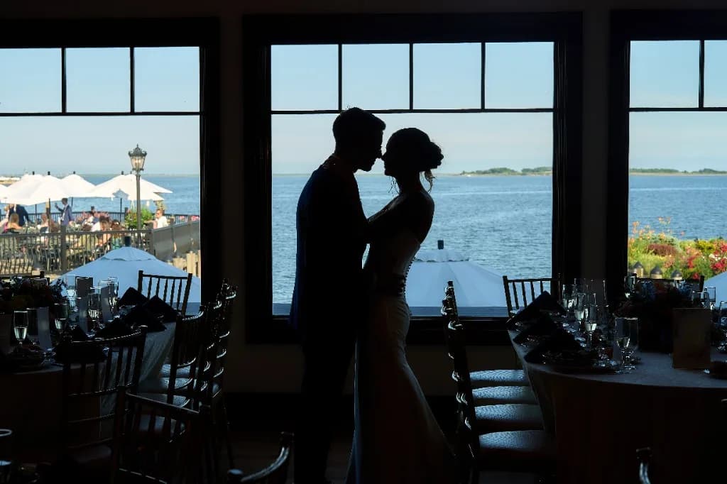 A still frame beside a film clip, Bride and groom feed each other cake at their reception at the Riviera Waterfront Mansion