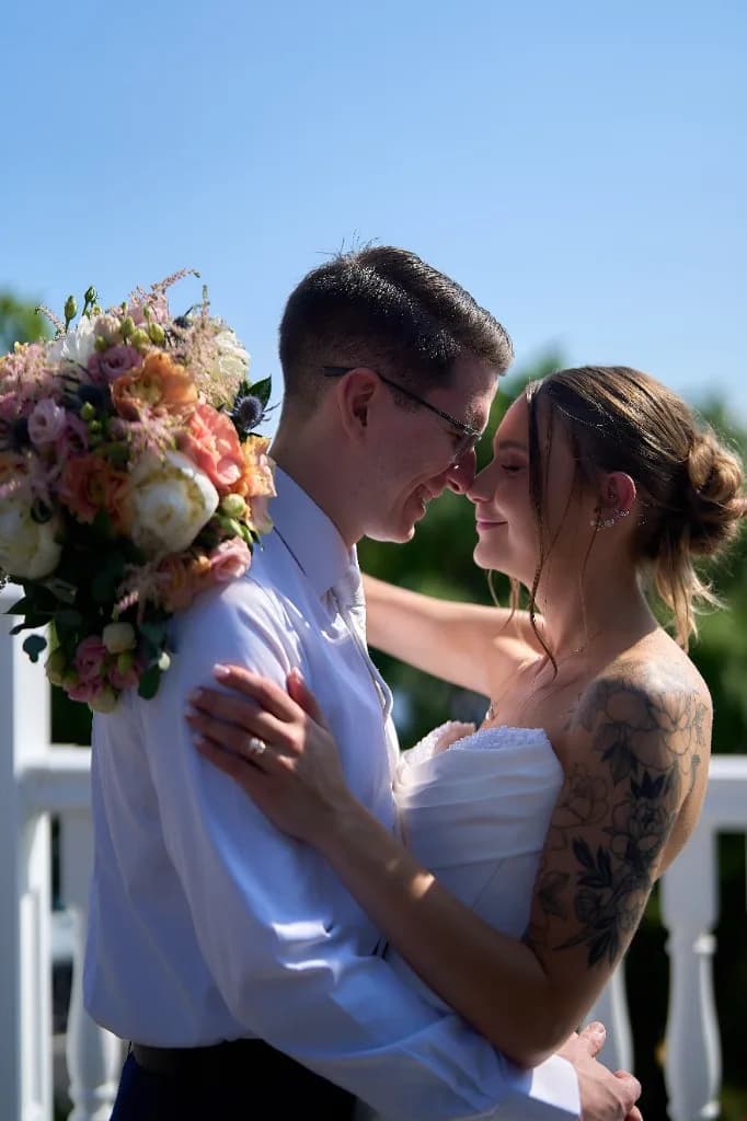 Bride and groom kiss at the end of the aisle in front of the waterfront gazebo at the Riviera