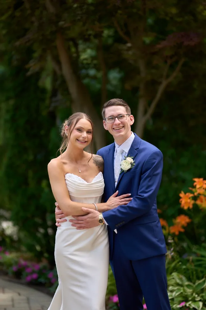 Groom waiting on the garden path as the bride walks toward him for their first look at the Riviera