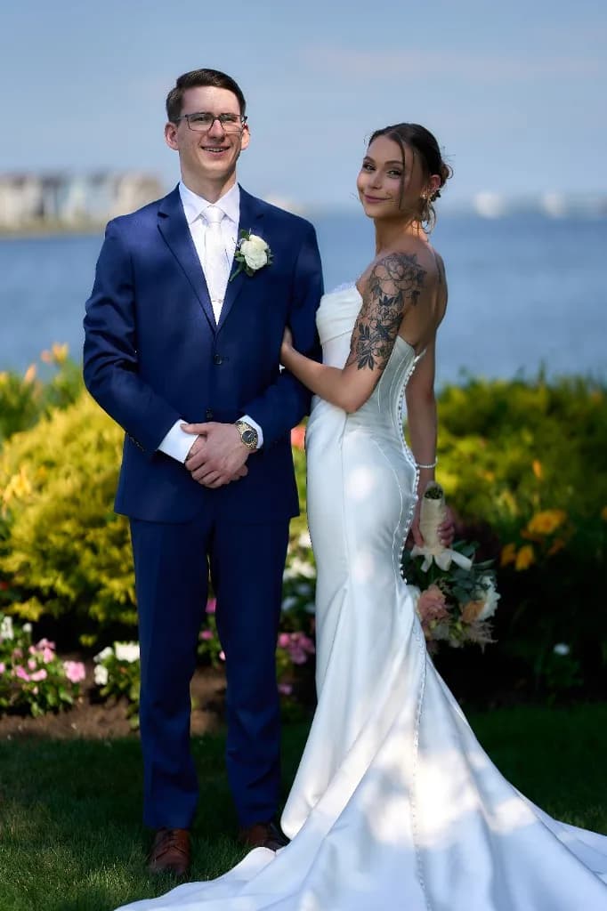 Bride and groom walking toward the waterfront gazebo at the Riviera Waterfront Mansion