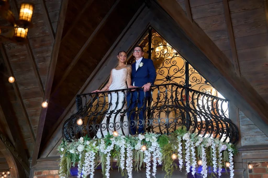 Hotel suite light against an estate facade, Bride and groom kiss among the set tables in the reception hall at the Riviera