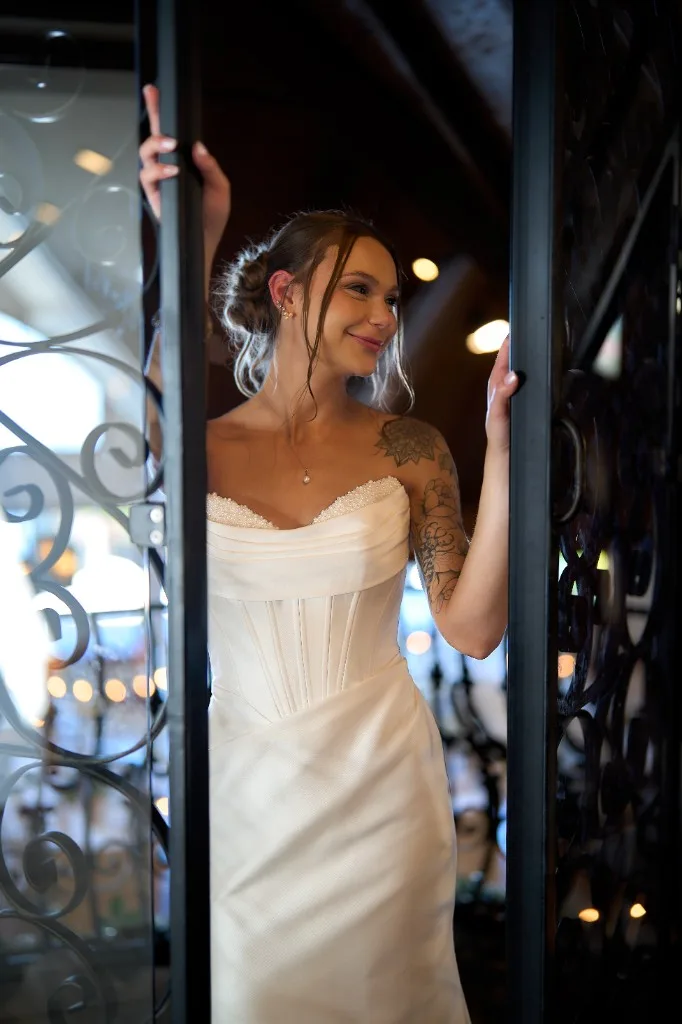 Hilton Long Island, Melville, Bride and groom about to kiss under a pearl trimmed veil against a blue sky at the Riviera