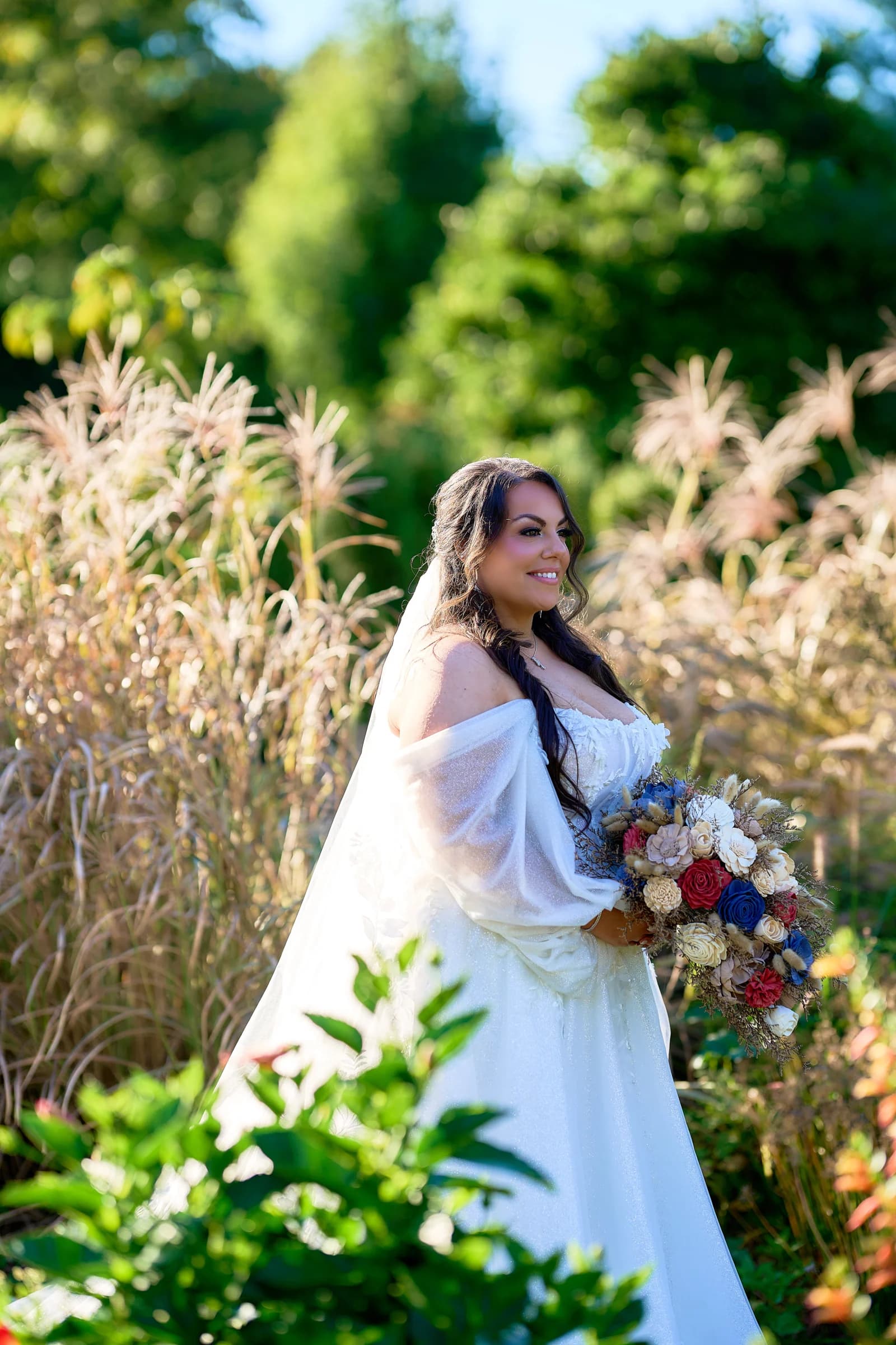 Getting ready, morning light, Stephanie in her veil among the tall grass, holding her bouquet at the Riviera Waterfront Mansion