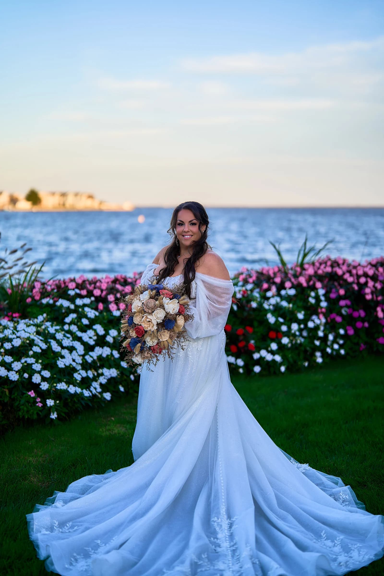 Stephanie in her off-the-shoulder gown with the train spread across the lawn at the Riviera