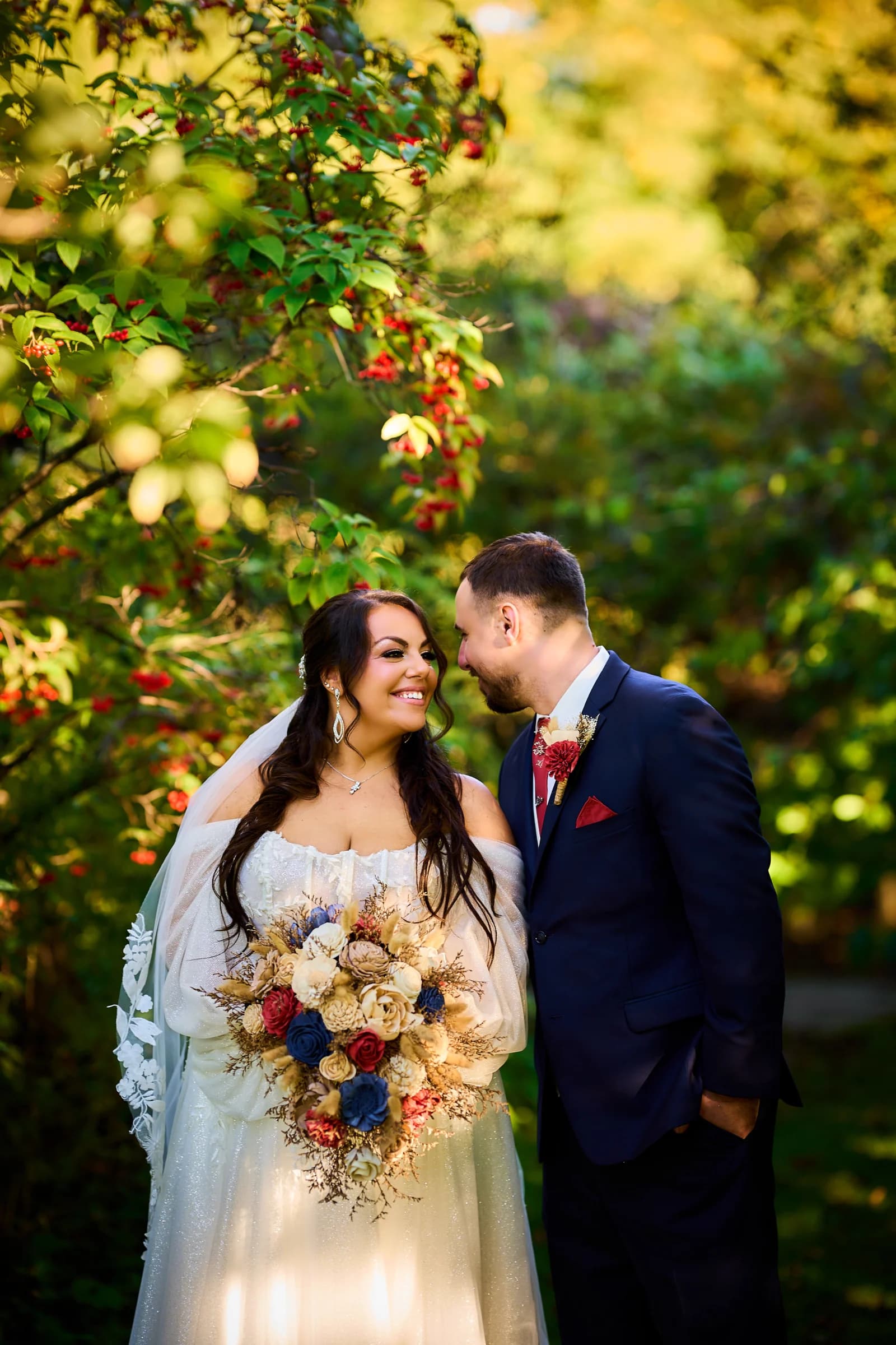 Stephanie and Peter in golden light beneath a berry tree at the Riviera Waterfront Mansion