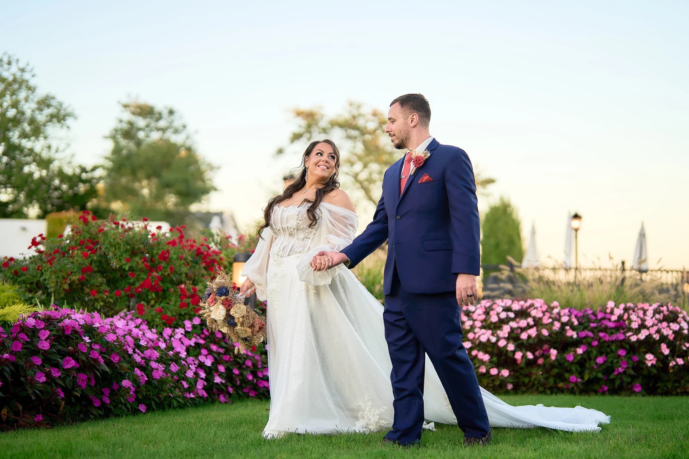Bedell Cellars, Cutchogue, Stephanie and Peter walking hand in hand past the flower beds at the Riviera