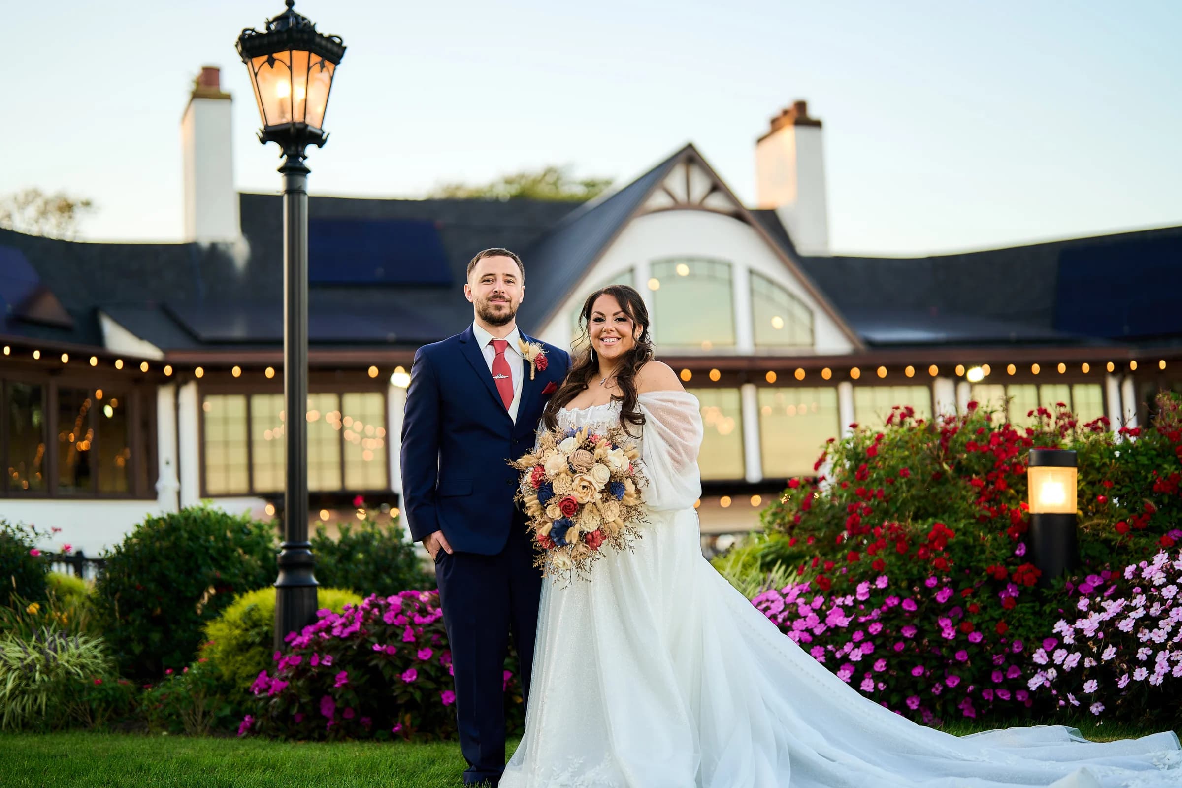 Stephanie and Peter on the lawn in front of the Riviera Waterfront Mansion