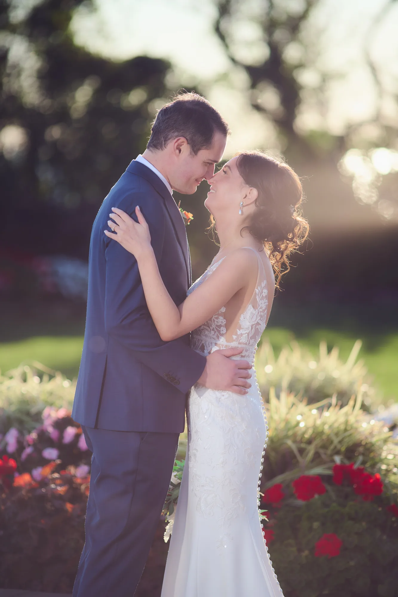 Bride and groom in a close embrace in soft golden hour light