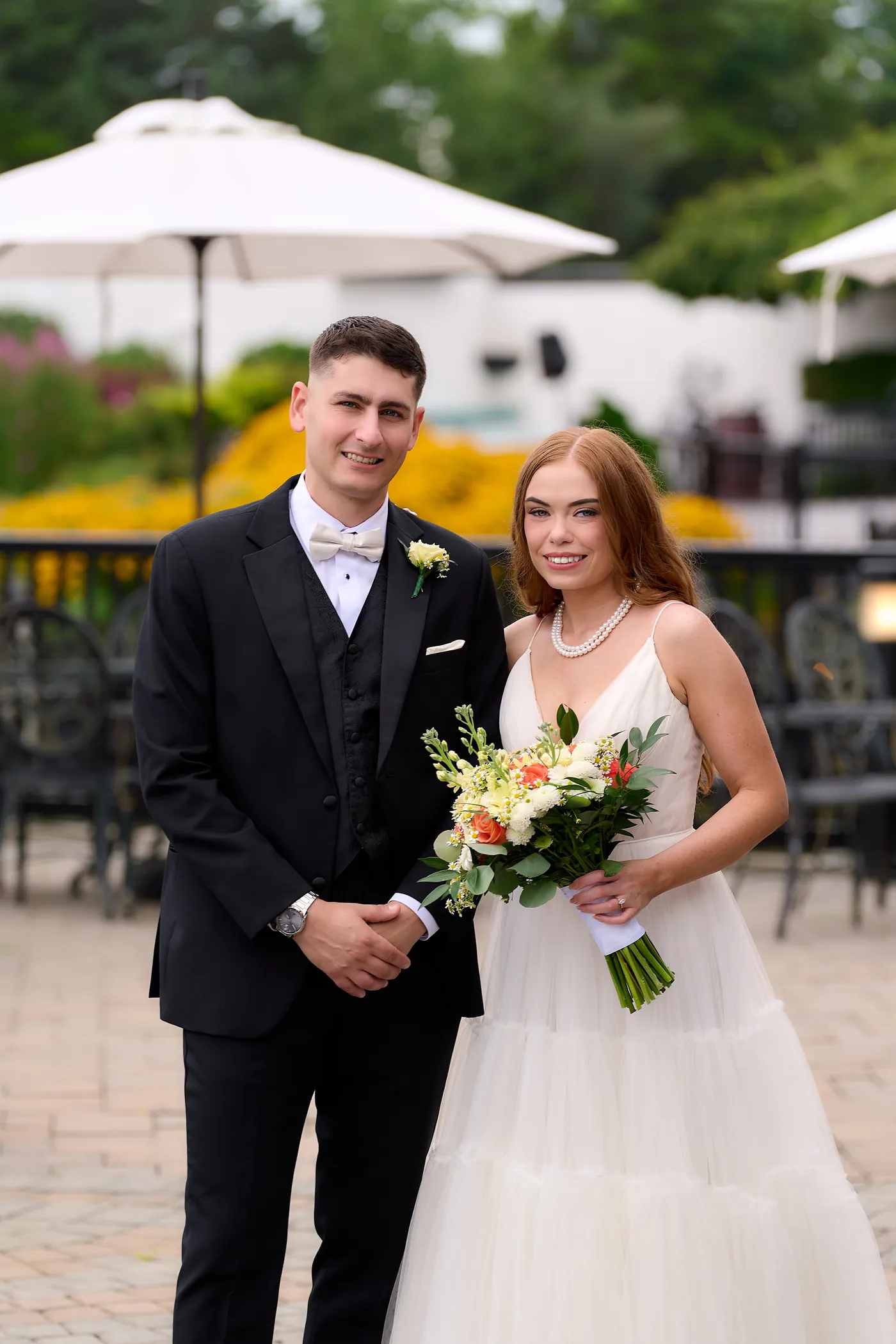 Two angles on the same ceremony moment, Bride and groom with a sunflower bouquet on their wedding day